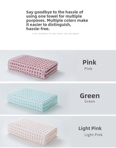 Detail showing the textured waffle weave pattern on pink and green cotton face towels