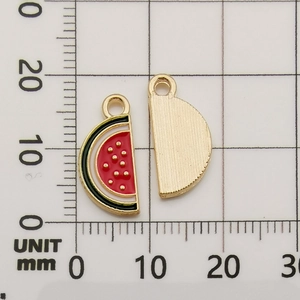 Macro detail of watermelon enamel alloy pendant showing 15mm length on scale grid