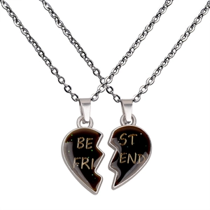 Detailed close-up of heart-shaped split necklaces with Best Friend engraving in black