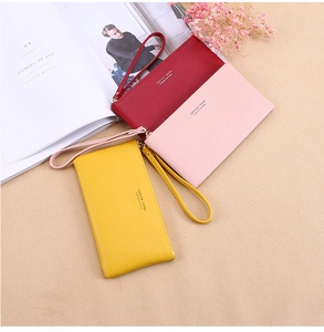 Three long minimalist zipper wristlet wallets in red, pink, and yellow colors