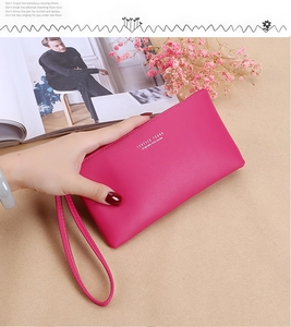 Handheld magenta long wallet featuring lychee pattern leather and a matching wrist strap