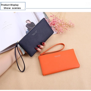 Close-up of stylish long zipper wallets in navy and orange with wrist straps