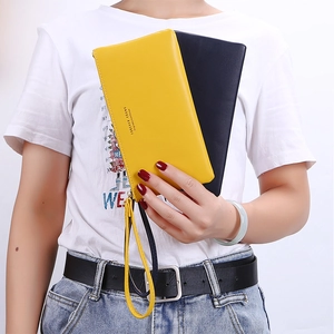 Close-up of long zip-around PU leather clutches with wristlets in yellow and dark blue