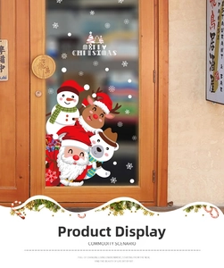 Detail showing festive Santa, reindeer and snowman decals on a glass shop door