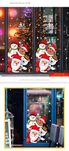 Detail of Christmas window stickers featuring Santa, snowmen, and reindeer on glass