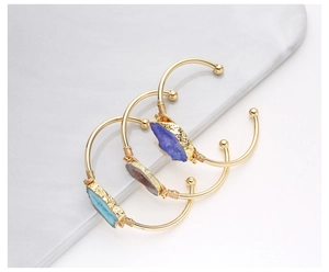 Detailed wire-wrapped copper bangles with natural druzy stones in blue, purple and grey