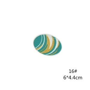 Detailed view of 6x4.4cm oval embroidery patch with green and gold abstract thread patterns