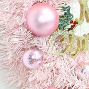 Pink Christmas wreath with matte and glossy baubles and a golden Merry Christmas sign