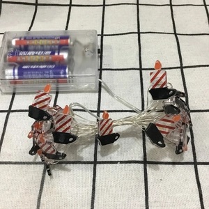 Detail of red and white striped LED candle string lights with clear battery power box