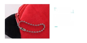 Detail of red plush coin purse featuring a smooth matching metal zipper and silver ball chain