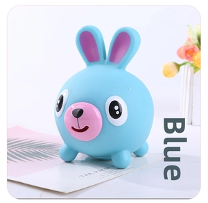Detail shot of a blue stress relief rabbit toy with soft texture and cartoon expression