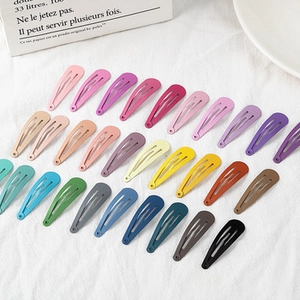 Flat lay of colorful 5cm metal snap hair clips in various matte candy colors