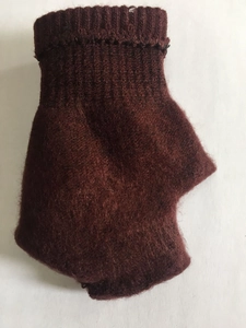 Close-up of wine red knitted gloves showing thick ribbed cuffs and fuzzy texture details