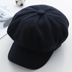 Top view of navy wool octagonal baker boy hat showing stitched panels and top button