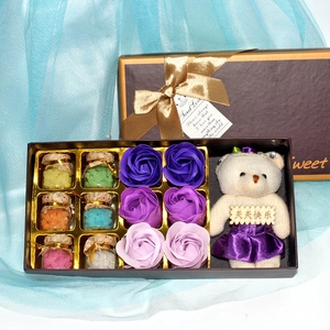 Detail of gift set featuring purple soap roses and a plush bear with glass crystal vials