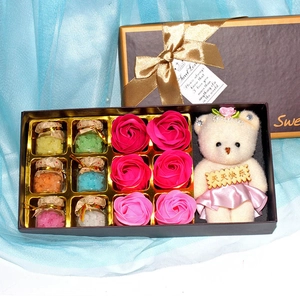 Detail view of gift set with 6 scent bottles, soap roses, and a small plush bear toy