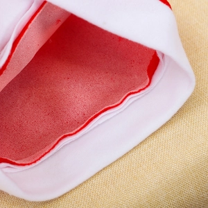 Plush Christmas hat with white exterior and red velvet interior lining detail