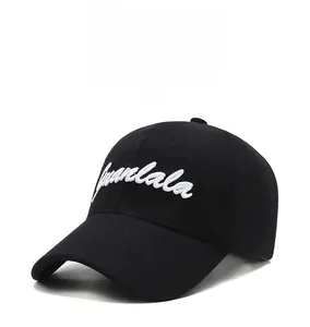 Close-up of white Juanlala letter embroidery on a premium black wool baseball cap