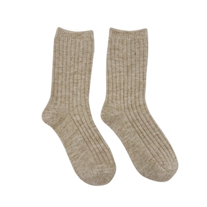 Minimalist beige wool blend knit socks with a ribbed texture on a clean white background