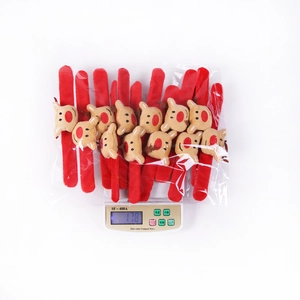 Christmas reindeer plush snap bracelets in bulk packaging being weighed on a digital scale