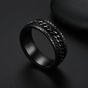 Macro shot of black stainless steel spinning ring with rotating chain inlay detail