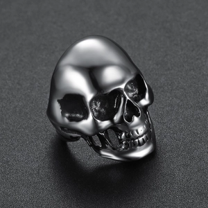 Macro view of a polished stainless steel skull ring with detailed anatomical carvings