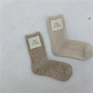 Detailed knit texture and ribbed patterns of wool socks in beige and light brown
