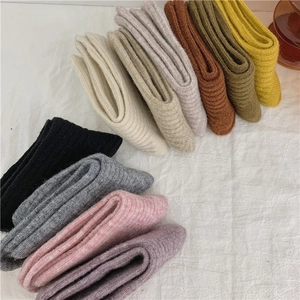Flat lay view of multi-color ribbed wool socks showing soft textures and knitted details