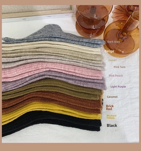 Detailed stack of multi-colored thick wool socks showing rich knit textures and soft fabrics