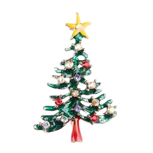Detail of Christmas tree brooch with green enamel, gold plating and colorful rhinestones