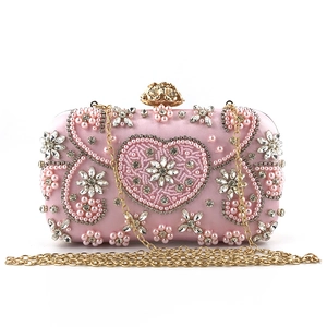 Exquisite pink evening clutch featuring handmade pearl embroidery and rhinestone heart pattern