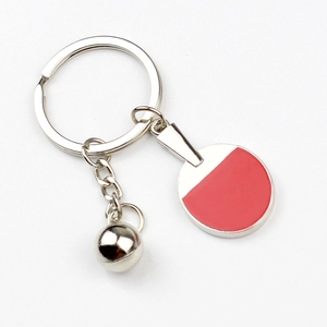 Metal table tennis paddle keychain with red racket and silver ball charm for sports fans
