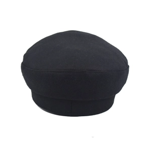 Detailed top view of a black wool blend octagonal baker boy hat on a white background
