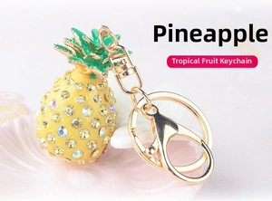 Close-up of sparkling pineapple keychain with crystals and gold lobster clasp