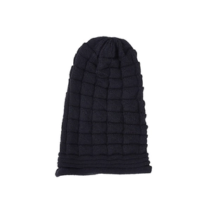 Close-up of black waffle knit texture on women's winter beanie hat for outdoor