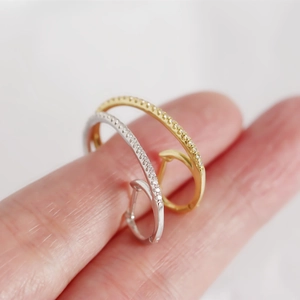Close-up of gold and silver S925 sterling silver ear cuffs with double-row rhinestones