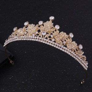 Detailed view of leaf pattern tiara with sparkling rhinestones and gold alloy frame