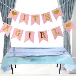 Pink It's a Girl banner displayed over a shiny blue metallic foil party tablecloth