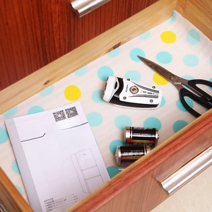 Moisture-proof cabinet liner with blue and yellow dots in a wooden drawer with tools