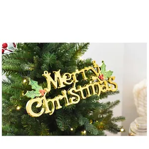Golden Merry Christmas sign with holly berries hanging on a decorated Xmas tree
