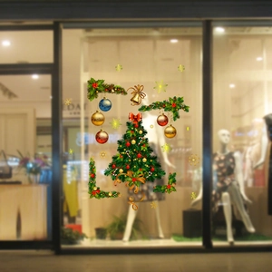 Christmas window sticker showing a decorated tree and gold ornaments on shop glass