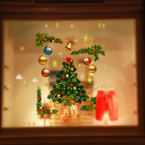 Detailed Christmas window stickers featuring green trees and gold balls on shop glass