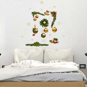 Christmas wall stickers with pine wreath and gold bells over bed in a cozy bedroom decor