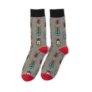 Detail of gray mid-calf socks with pixel insect patterns and red heel and toe accents