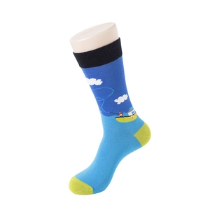 Detail of colorful knitted crew sock featuring fishing patterns and vibrant color blocking
