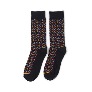 Detailed view of black mid-calf socks featuring colorful floral knit patterns and ribbed cuffs
