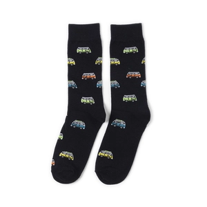 Detail of black cotton socks featuring colorful pixel art truck patterns on white background