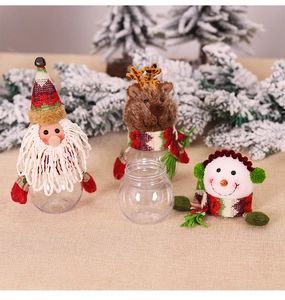 Close-up of festive Santa, Snowman, and Reindeer candy jars with textured knit hats