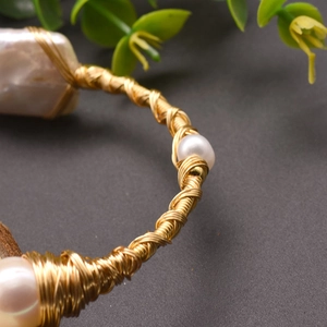Handcrafted Baroque freshwater pearl bracelet with intricate gold wire wrapping details