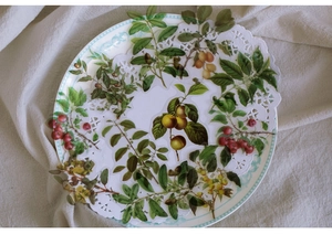 Detailed view of botanical PET stickers with green leaves on white lace and porcelain